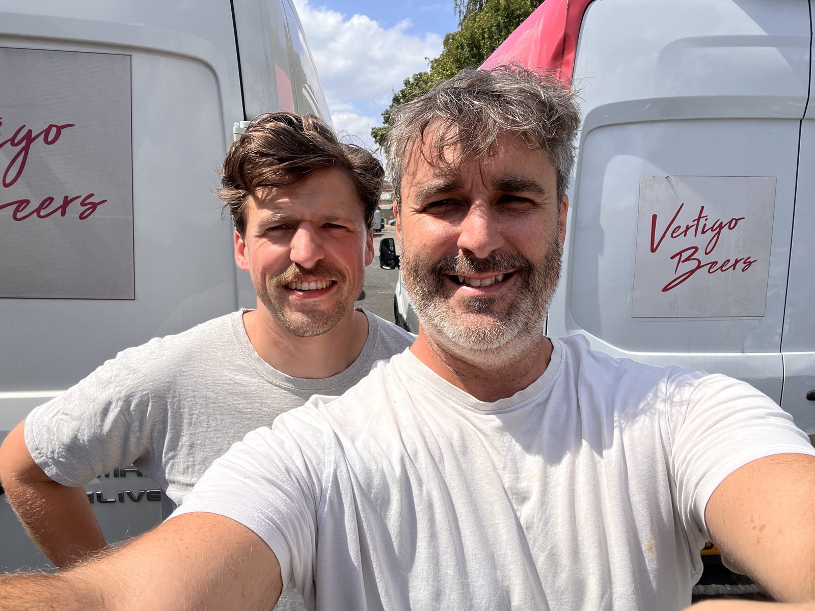 TJ and Ralph of Vertigo Beers in front of the delivery vans